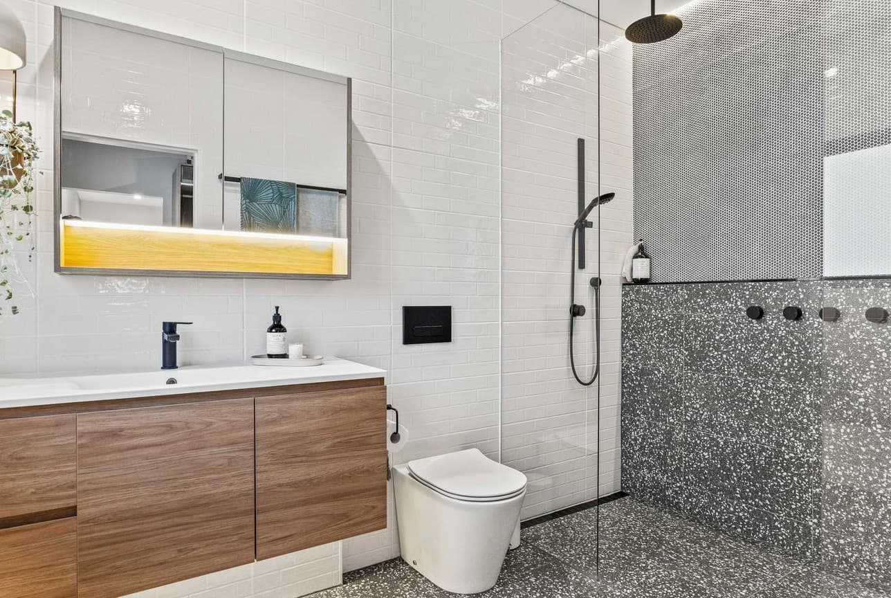 Modern bathroom with integrated mirror and shower lighting